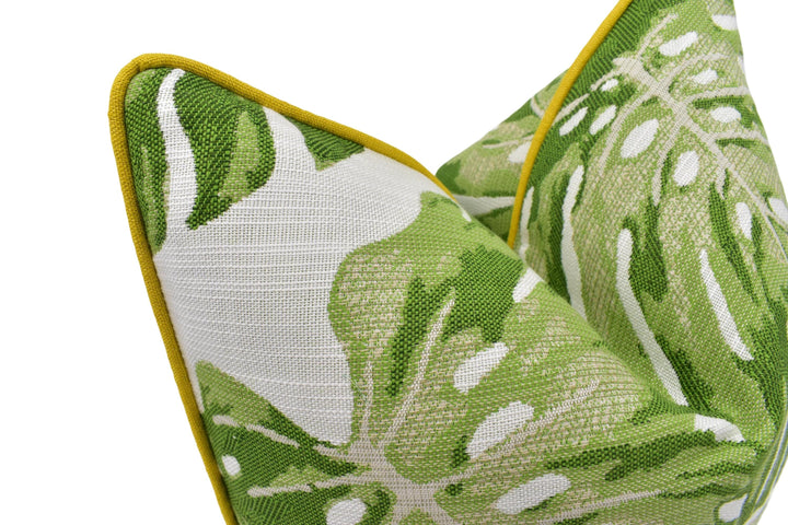 a close-up view of a green and white patterned fabric, possibly a pillow or cushion, with a yellow border.