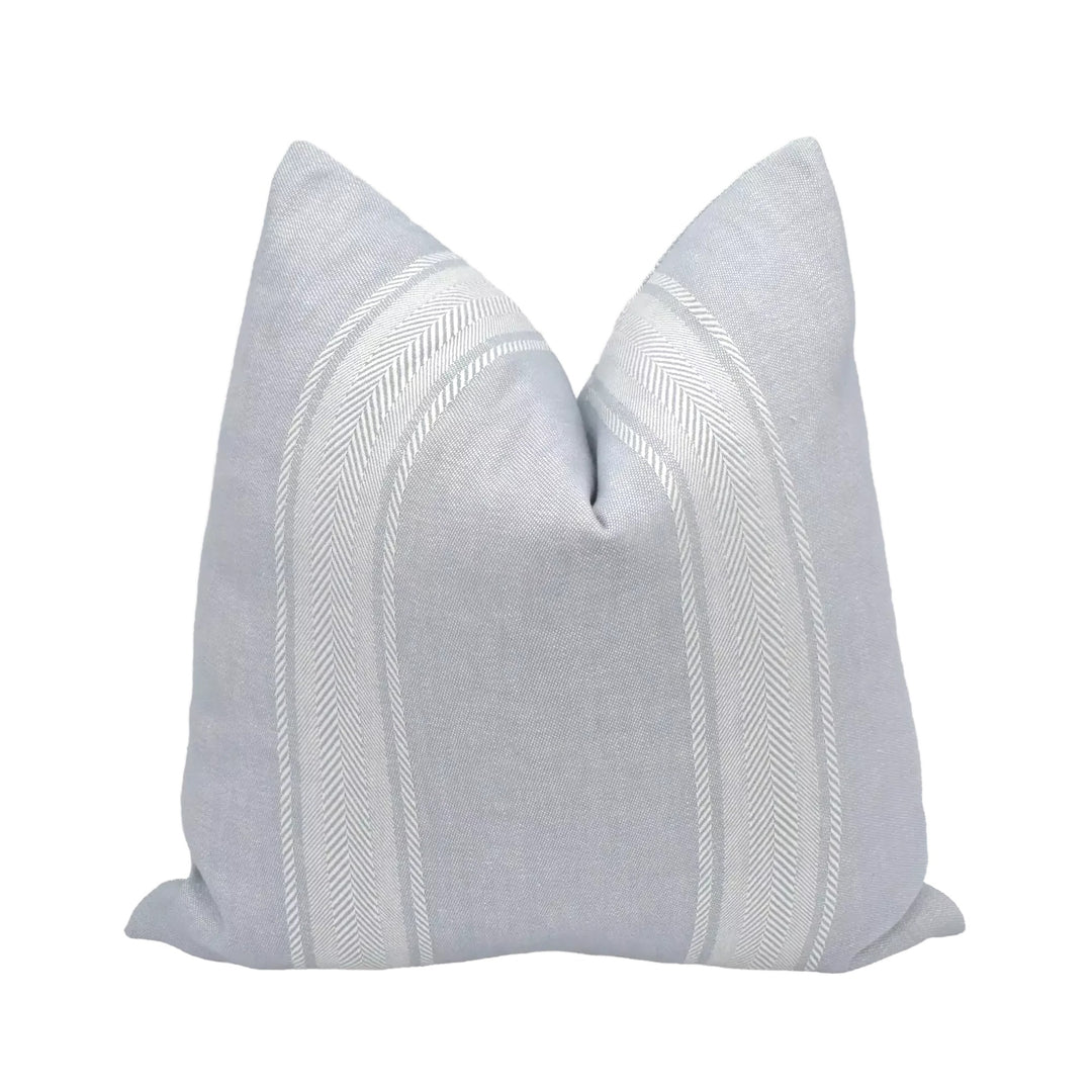 A gray and white striped pillow is displayed against a white background.