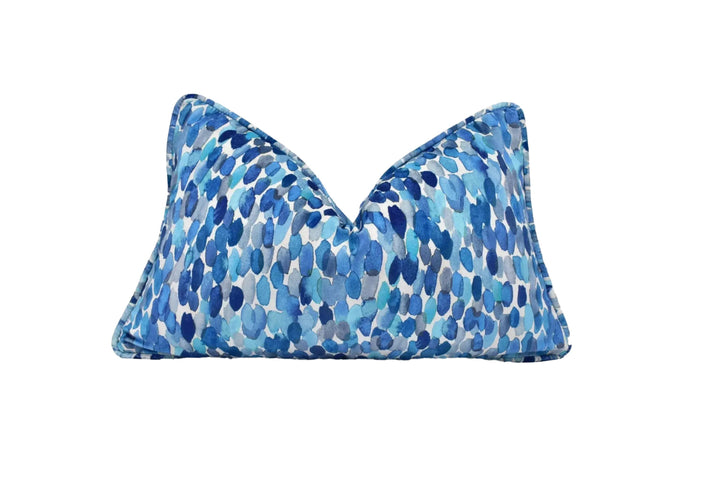 A blue and white patterned pillow with a watercolor-like design.