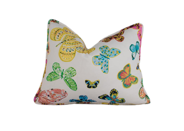a white pillow with colorful butterflies on it