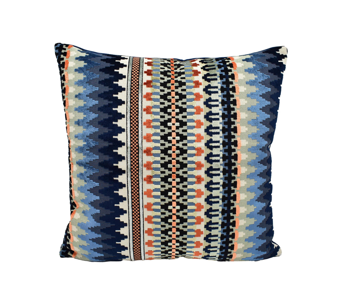 A square throw pillow with a vibrant, colorful geometric pattern in shades of blue, orange, and gray.
