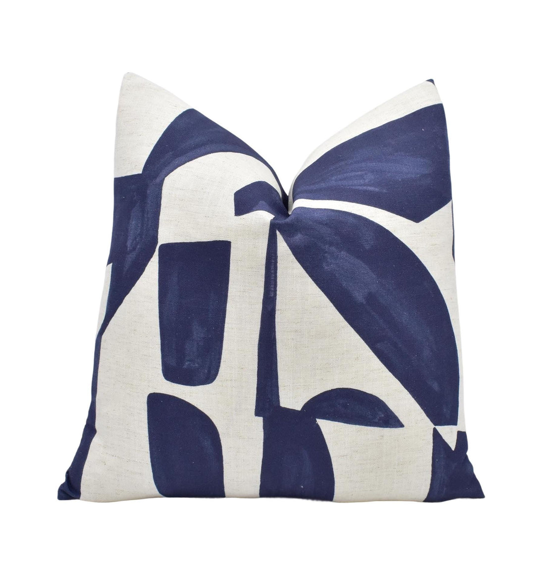 a blue and white pillow on a white background