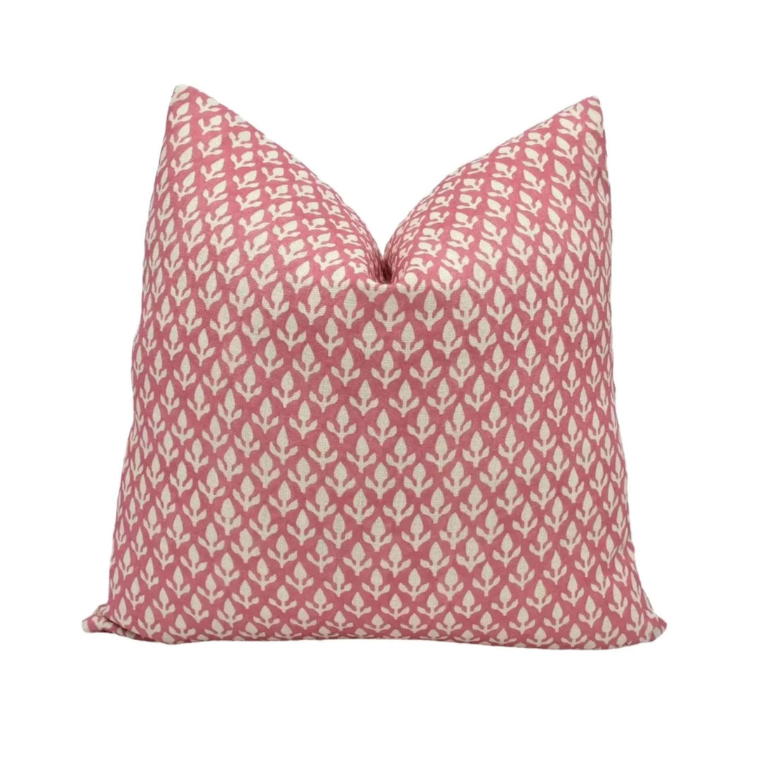 A single pillow with a repeating pattern of pink and white flowers or leaves.