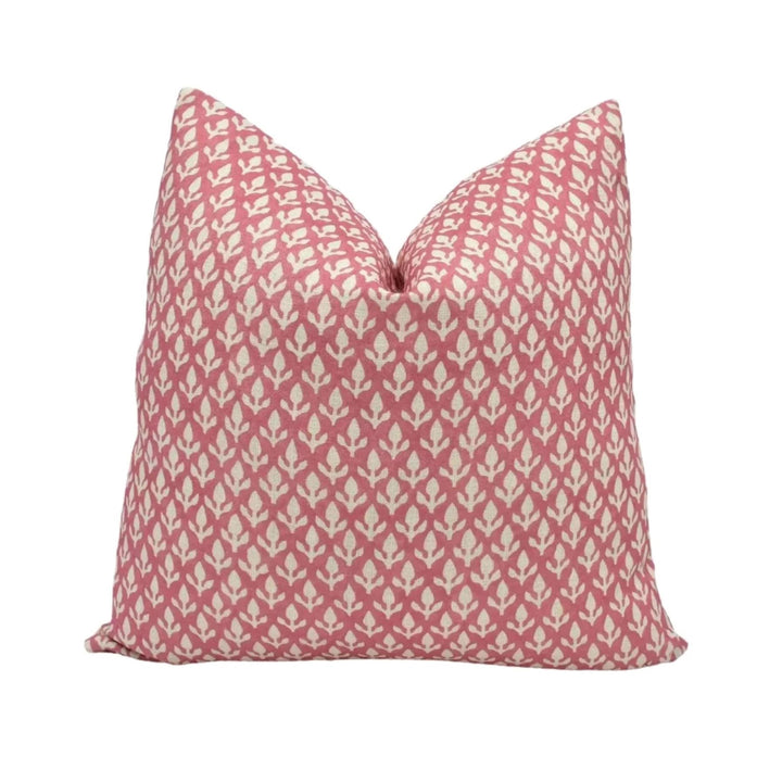 A single pillow with a repeating pattern of pink and white flowers or leaves.