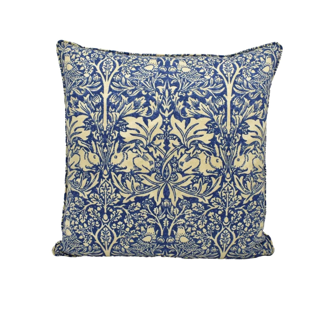 A square throw pillow with a blue and white floral pattern.