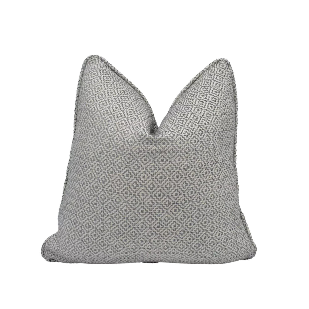 a gray and white patterned pillow against a white background.