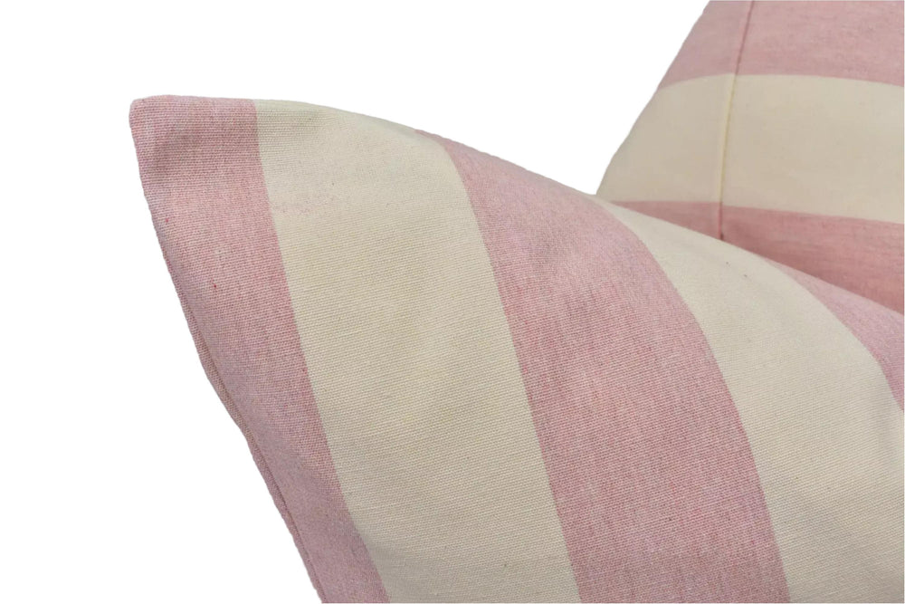 A close-up view of a pink and white striped pillow, with the fabric appearing soft and textured.