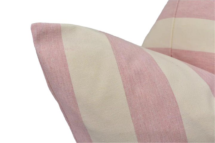 A close-up view of a pink and white striped pillow, with the fabric appearing soft and textured.
