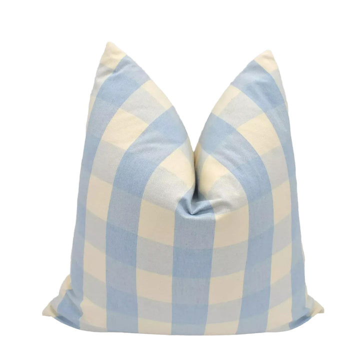 A blue and white checkered pillow is placed against a white background.