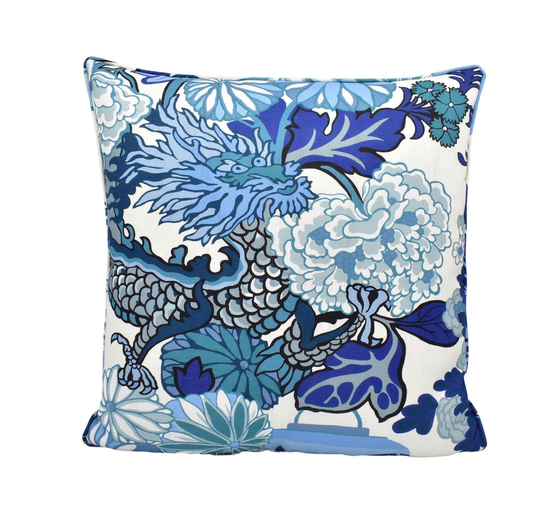 a blue and white pillow with flowers on it