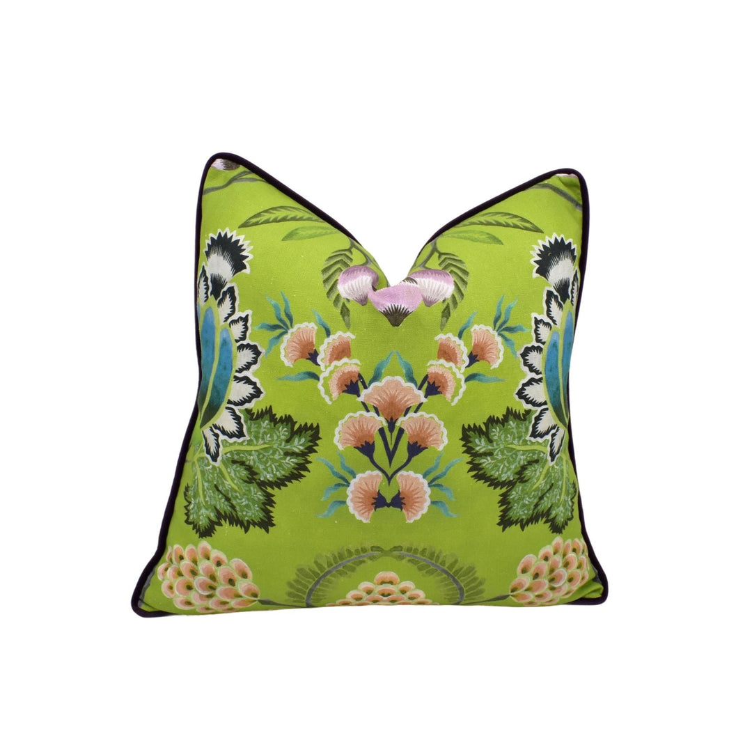 a green pillow with pink flowers on it