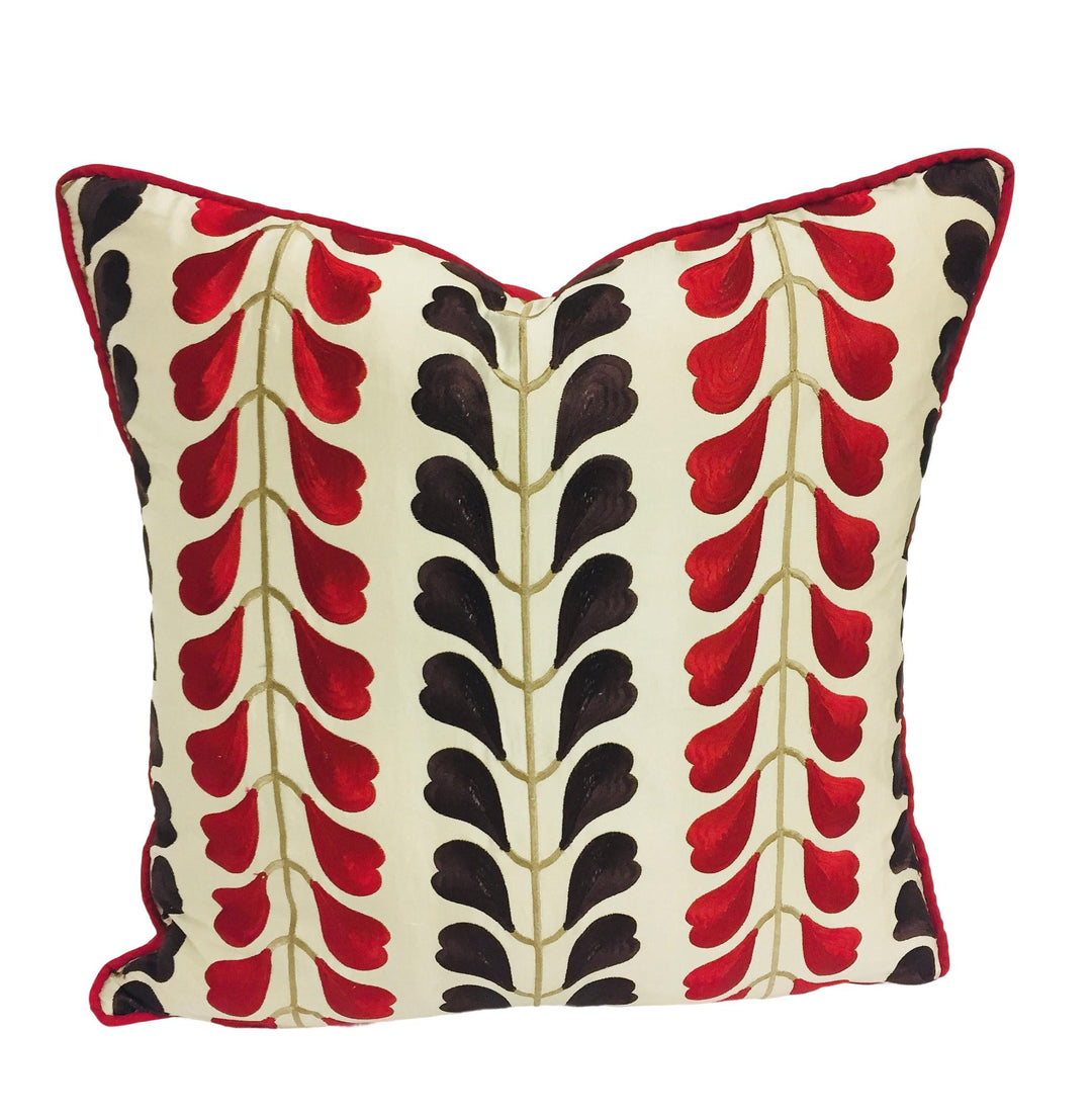 a red and black pillow on a white background