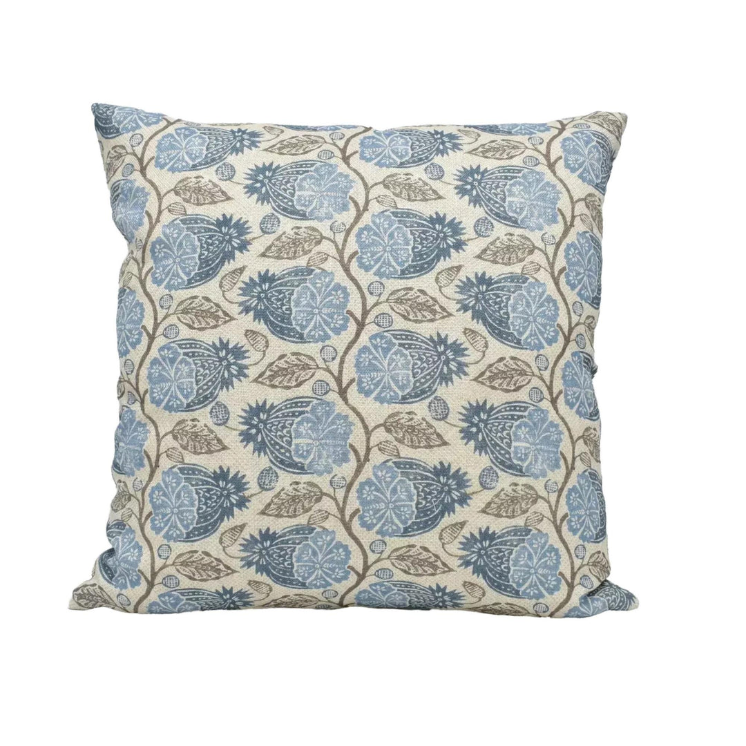 A square throw pillow with a repeating floral pattern in shades of blue and brown.