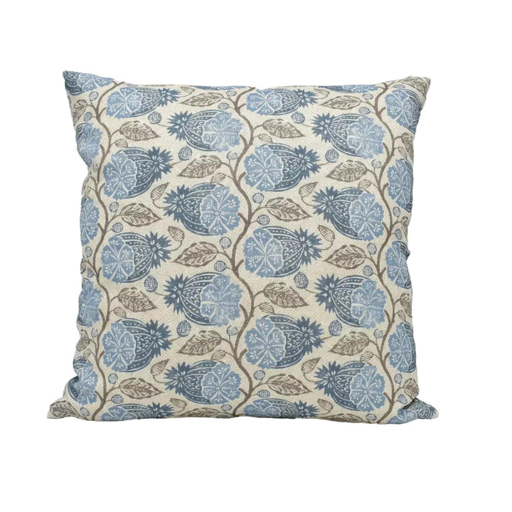 A square throw pillow with a repeating floral pattern in shades of blue and brown.