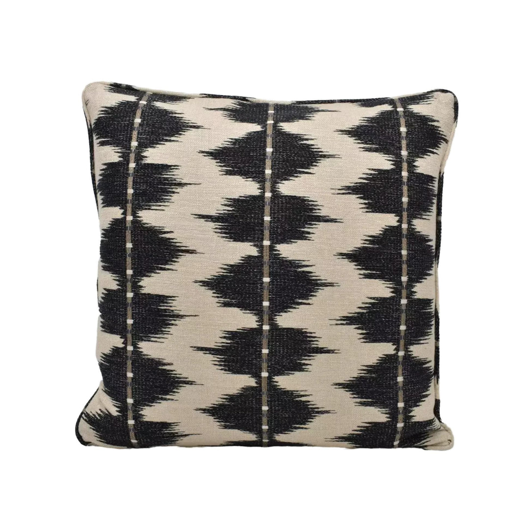 A square throw pillow with a black and white geometric pattern.