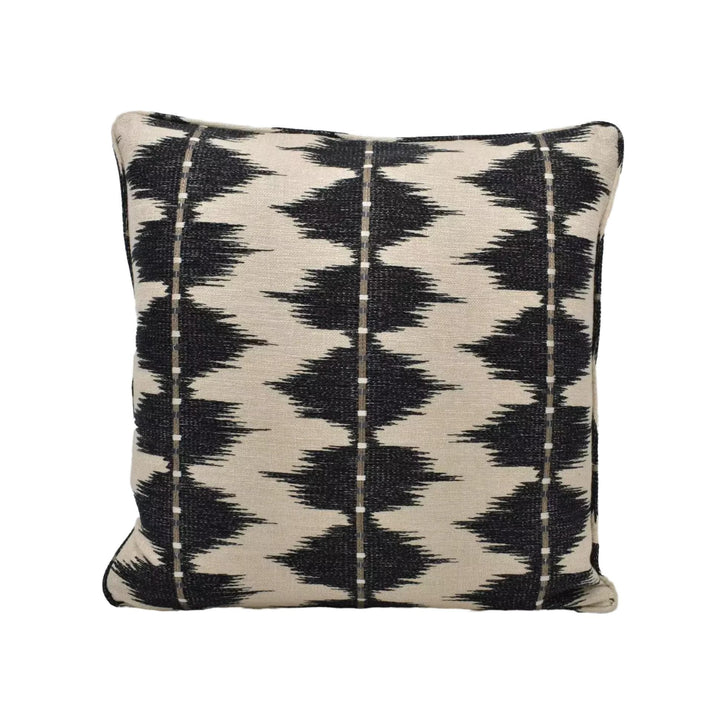 A square throw pillow with a black and white geometric pattern.