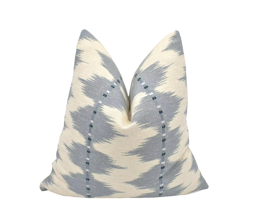 a single pillow with a gray and white zigzag pattern, placed against a white background.