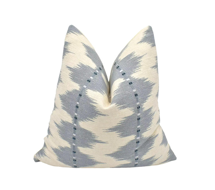 a single pillow with a gray and white zigzag pattern, placed against a white background.