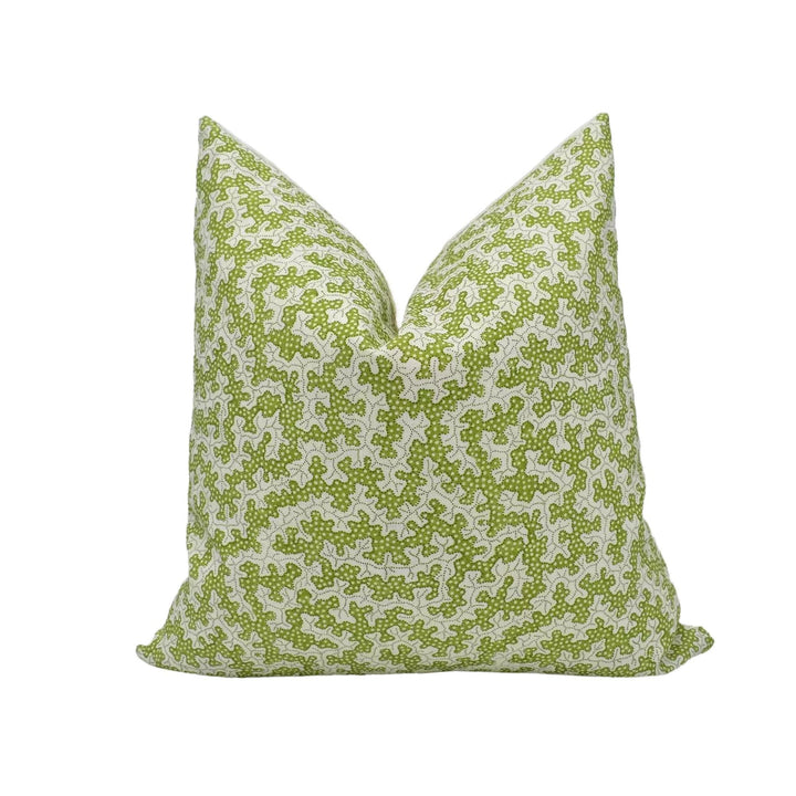 A green and white patterned throw pillow is displayed against a white background.