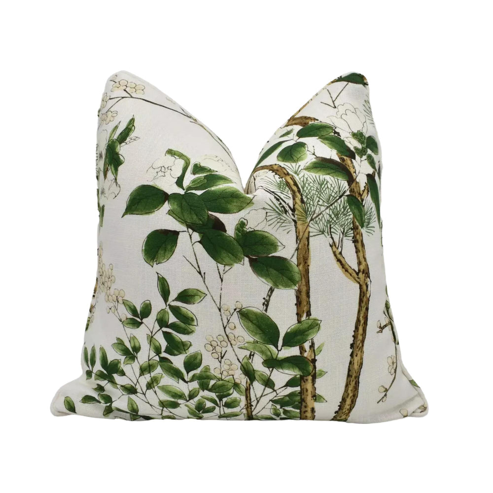 a white pillow with a green leaf and branch pattern.