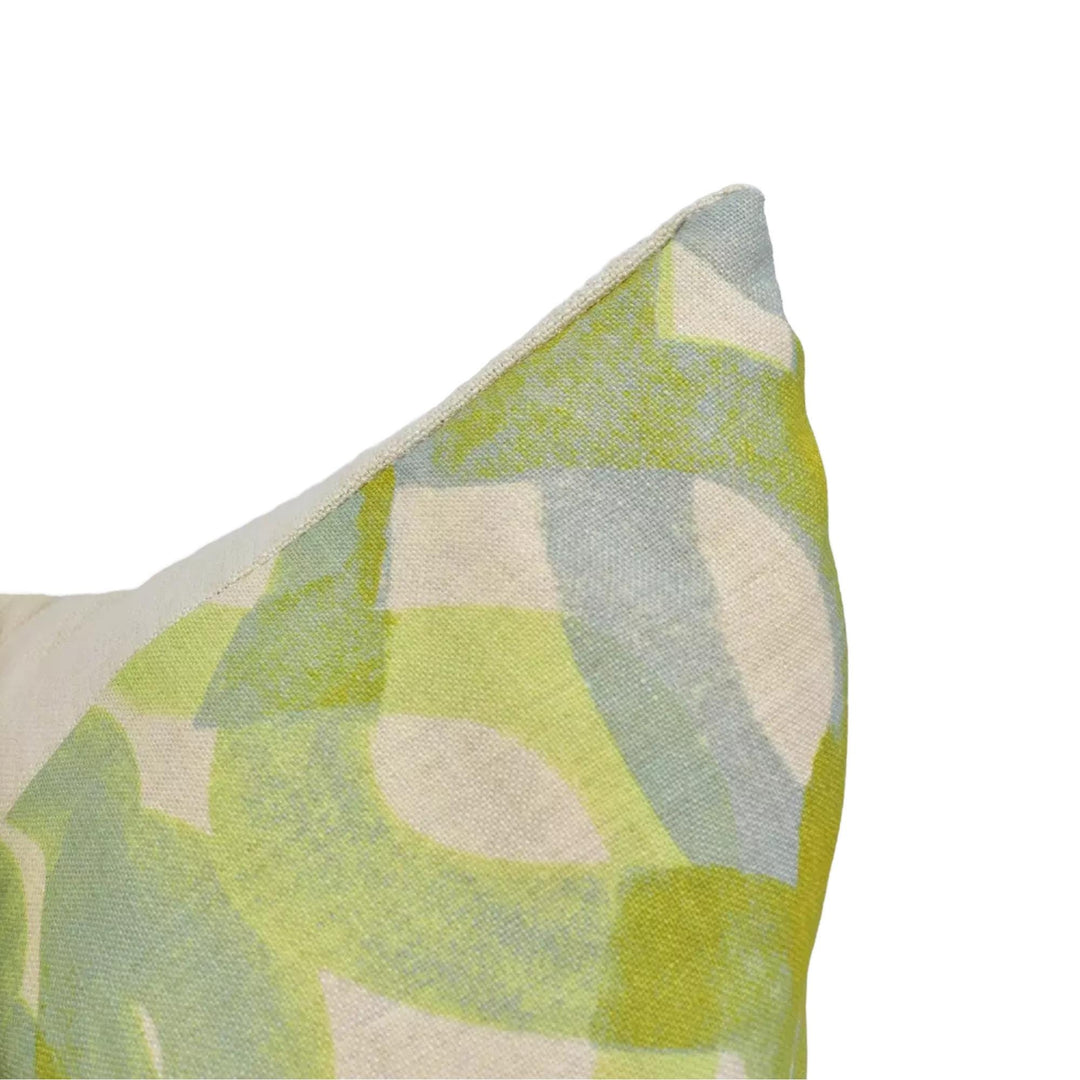 A close-up view of a colorful, abstract patterned fabric or textile, with a mix of green, yellow, and gray colors.