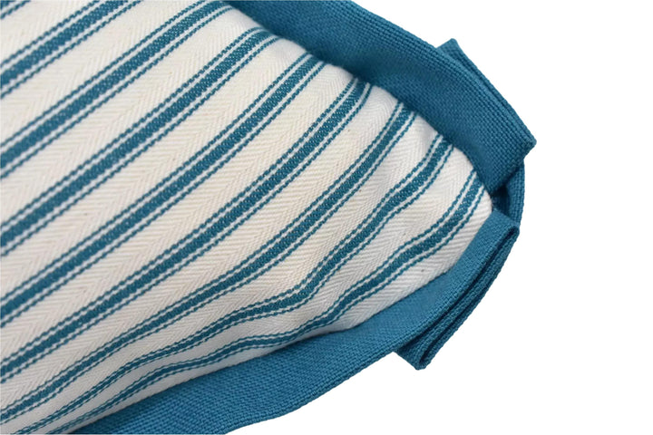 A close-up view of a striped fabric with a blue trim, likely a pillow or cushion.