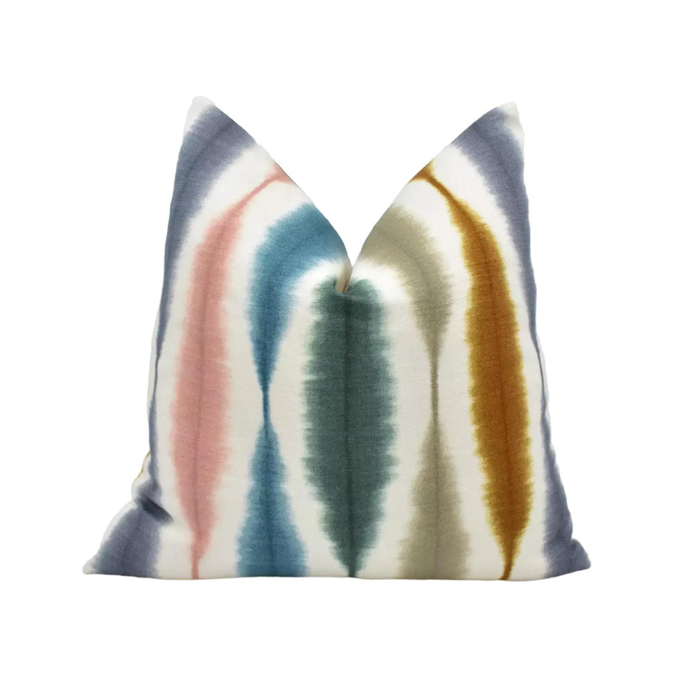 a colorful, tie-dye pillow with a vibrant pattern of stripes in various colors.