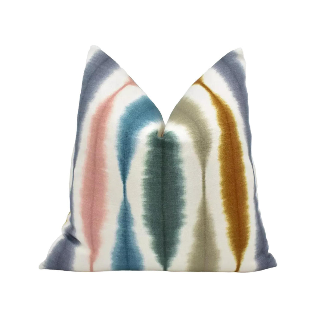 a colorful, tie-dye pillow with a vibrant pattern of stripes in various colors.
