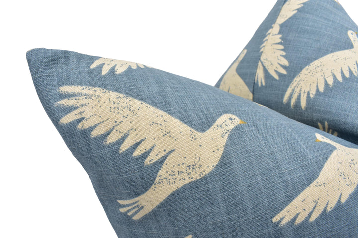 two blue pillows with white birds on them