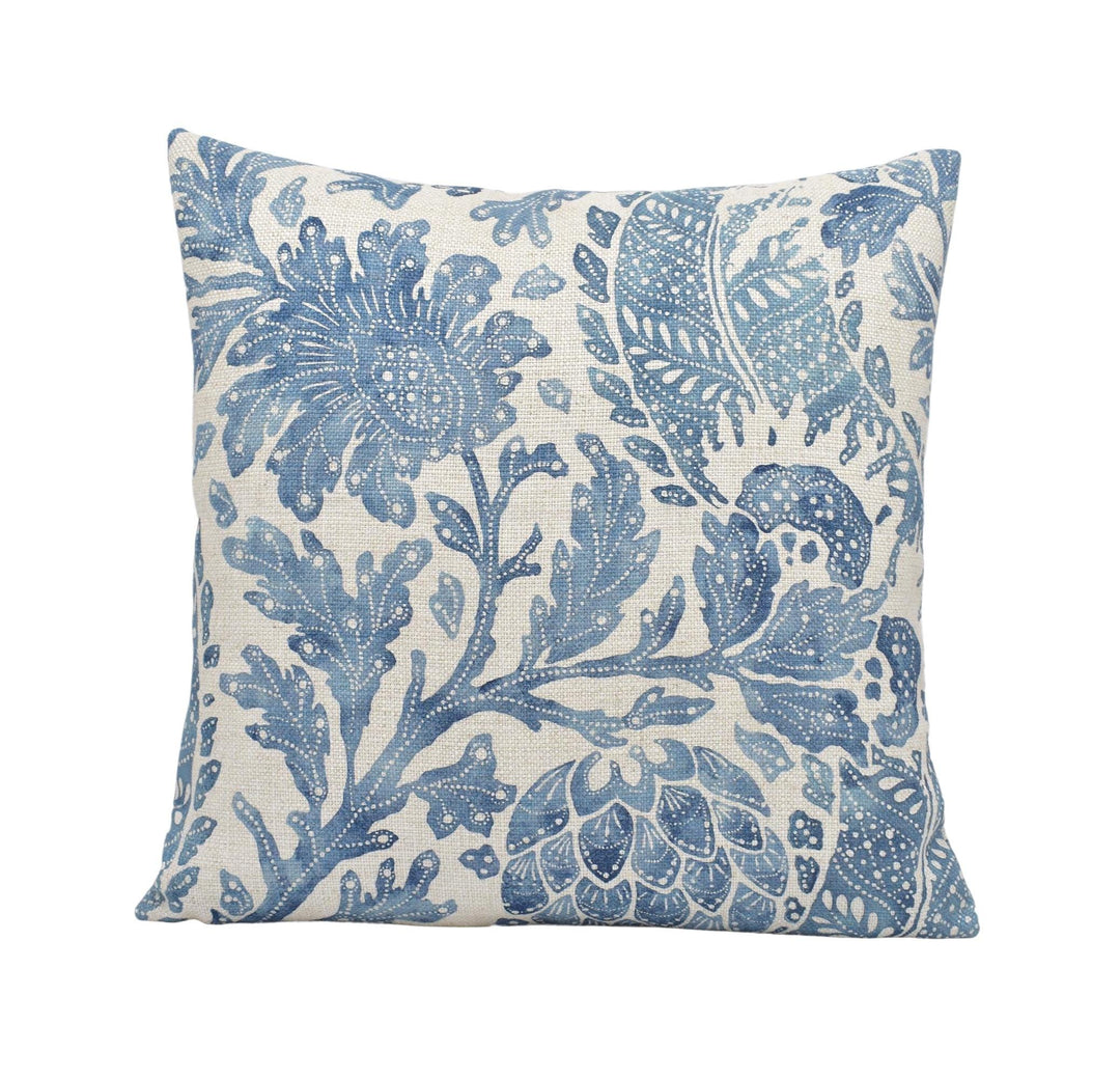 a blue and white pillow on a white background