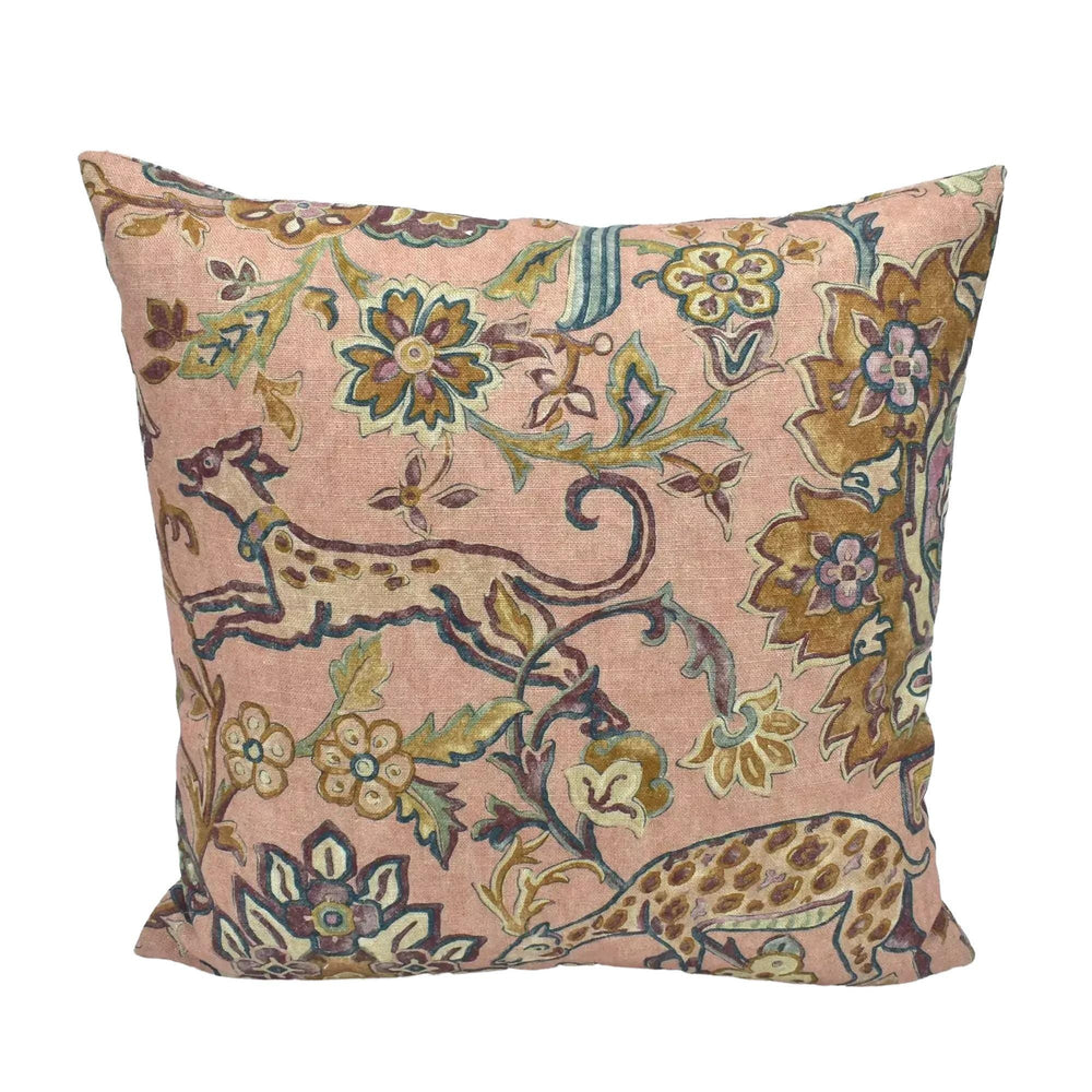 A decorative throw pillow with a floral pattern in shades of pink and green.