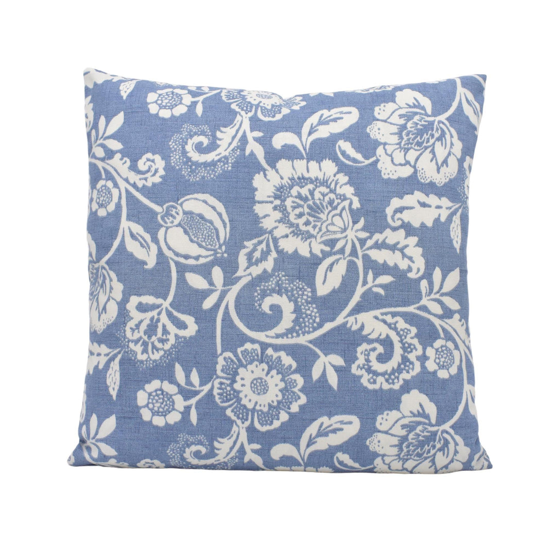 a blue pillow with white flowers on it