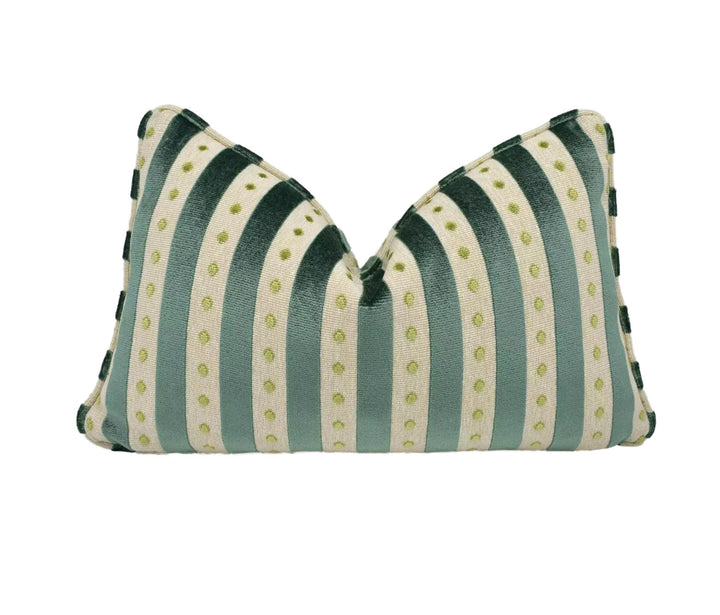 A decorative pillow with a striped pattern in shades of green and white, featuring small green dots on the fabric.