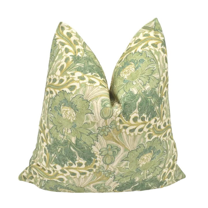 A decorative green and white floral patterned pillow is displayed against a white background.