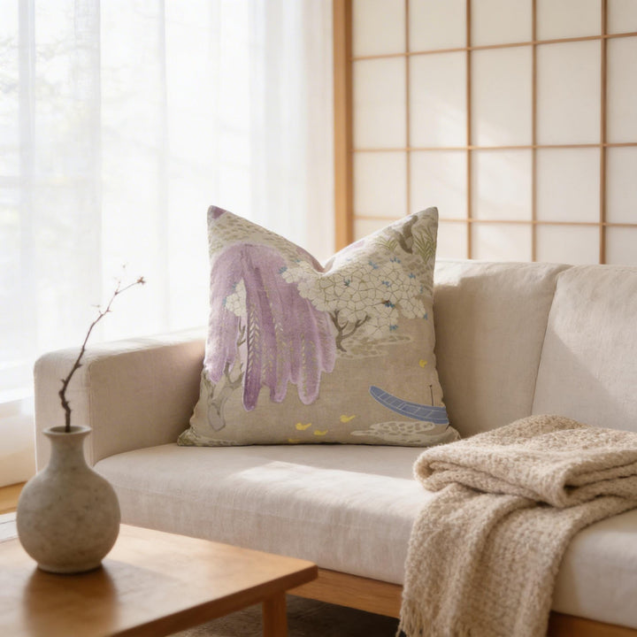 a cozy living room with a beige sofa, a wooden coffee table, and a decorative pillow with a floral design.