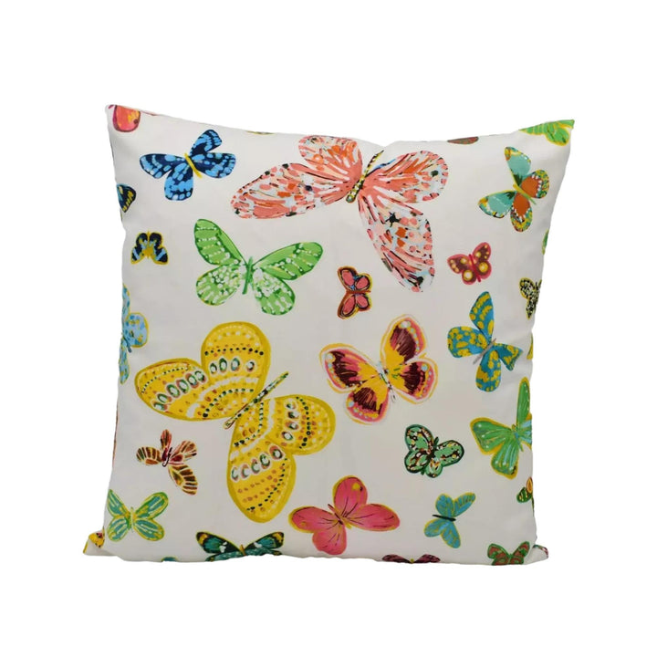 A white pillow with a vibrant and colorful butterfly pattern printed on it.