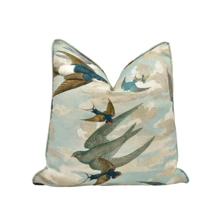 a pillow with a cloud and bird pattern.