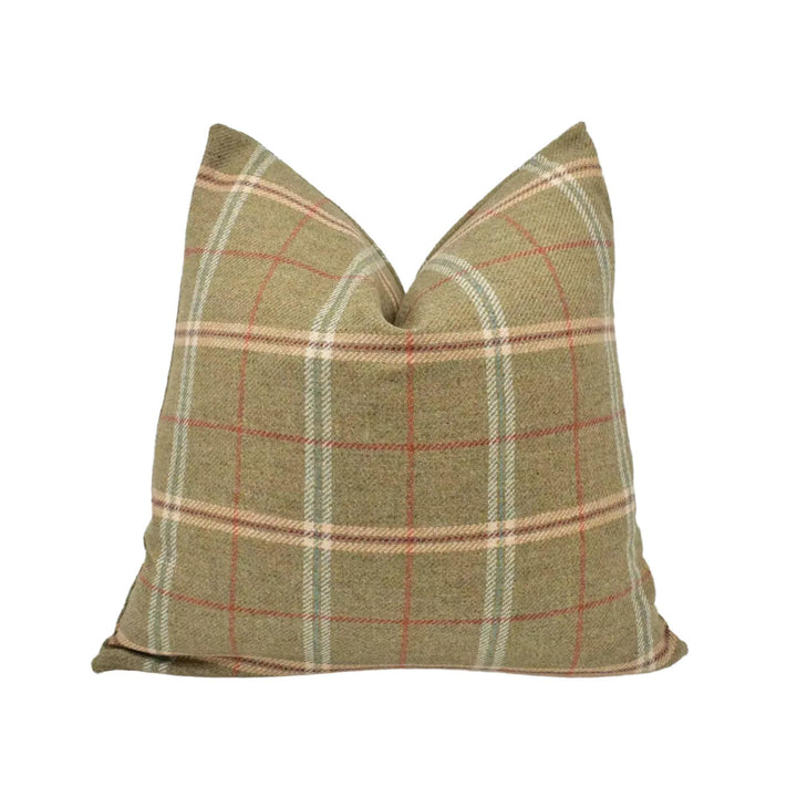 A pillow with a plaid pattern in shades of brown and beige.