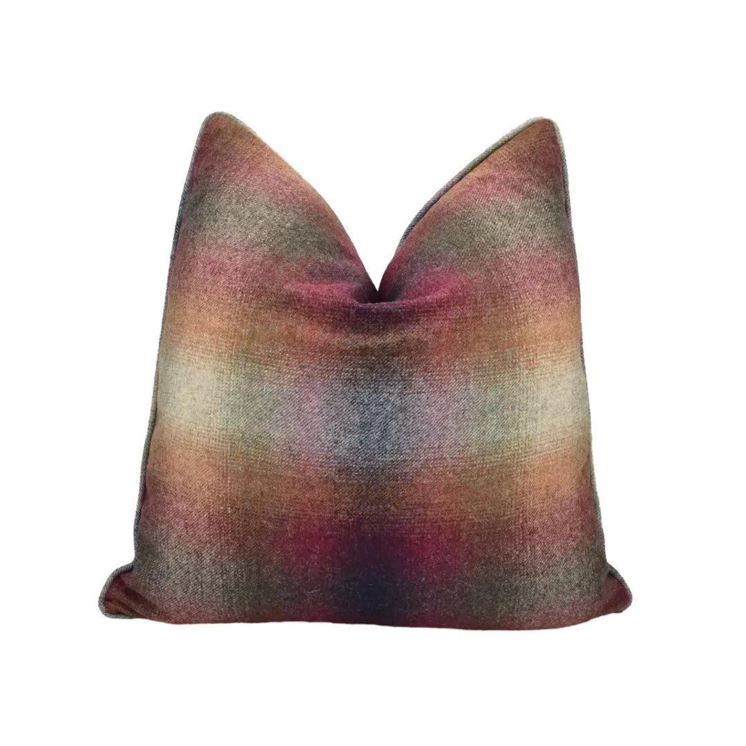 A colorful, textured throw pillow with a multicolored pattern.