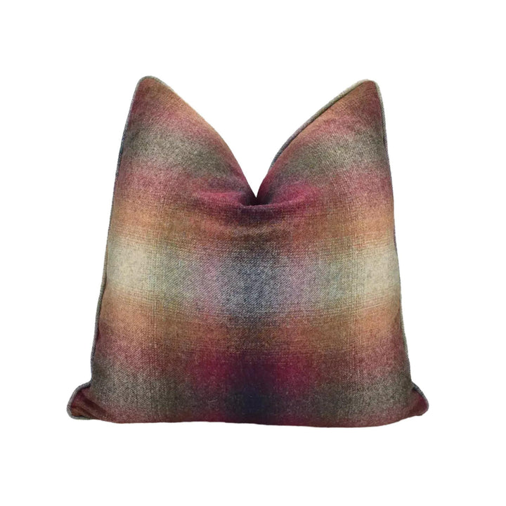 A colorful, textured throw pillow with a multicolored pattern.
