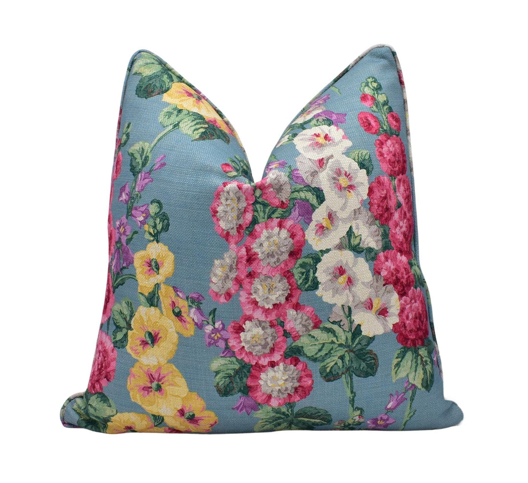 a blue floral pillow with pink and yellow flowers