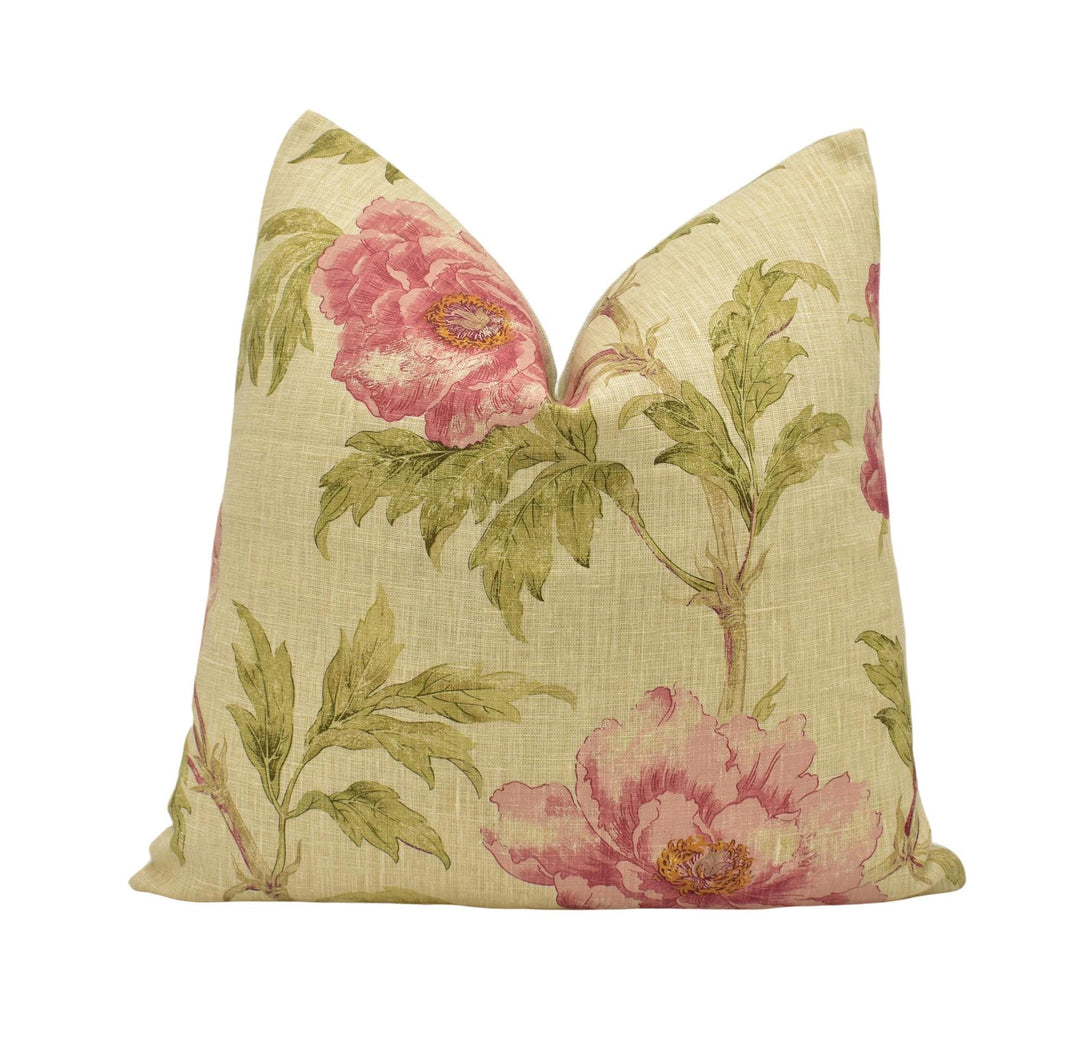 a pink flowered pillow on a white background