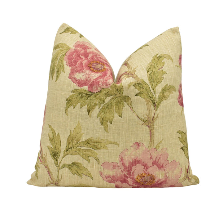 a pink flowered pillow on a white background