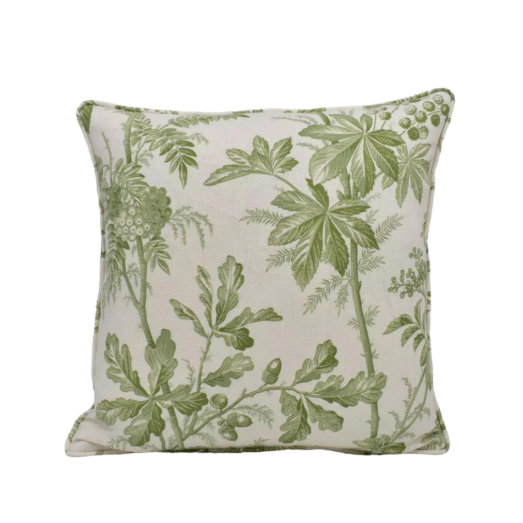 A square throw pillow with a green leaf pattern on a beige background.