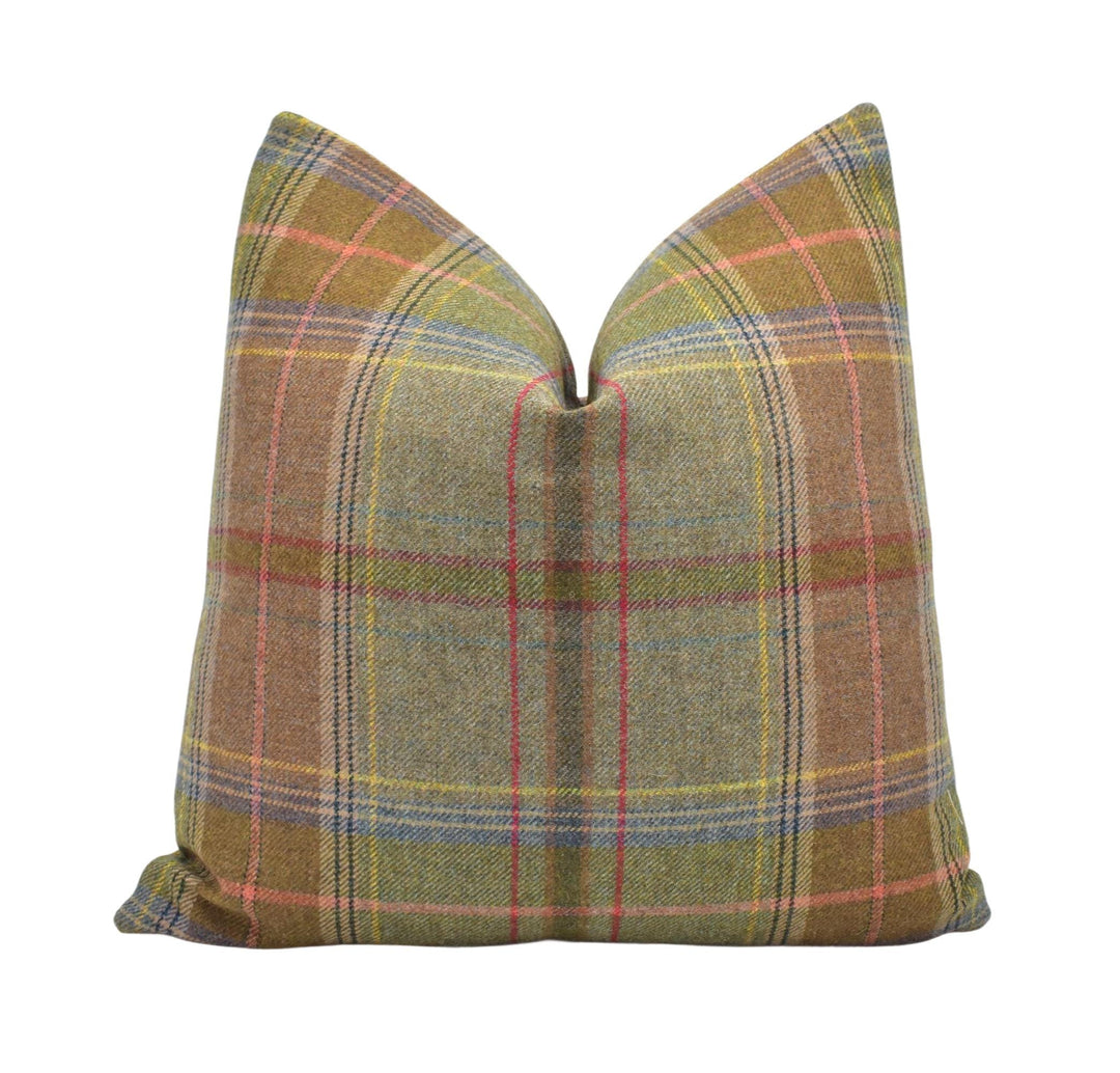 a brown plaid pillow with a green and red plaid pattern