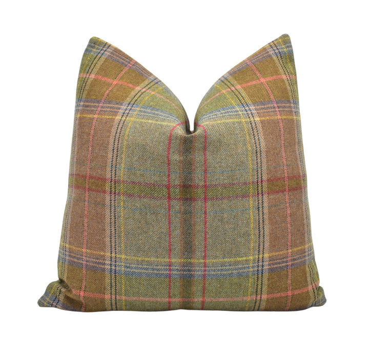 a brown plaid pillow with a green and red plaid pattern