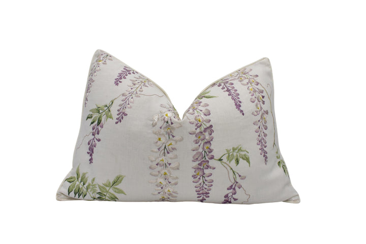a white pillow with purple flowers on it