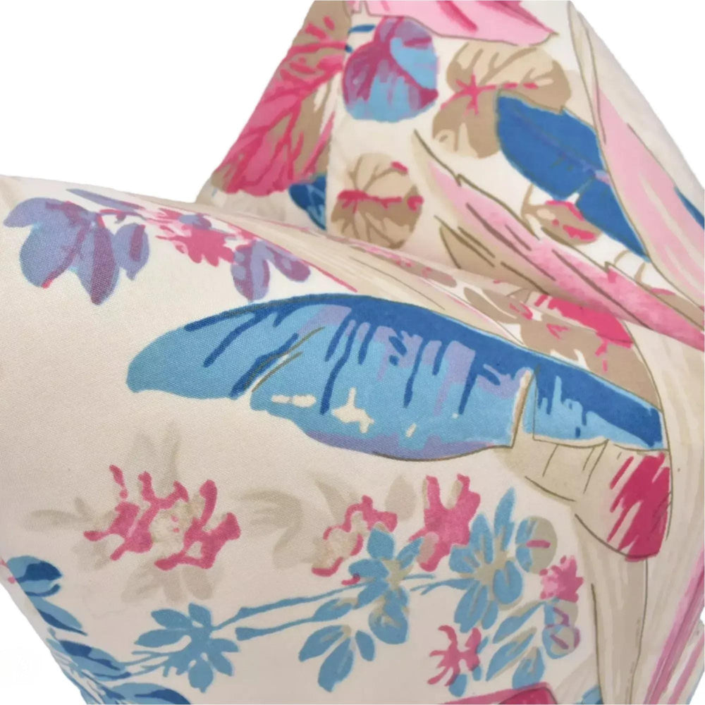 a close-up view of a colorful, floral-patterned fabric, possibly a pillow or cushion, with various shades of pink, blue, and green.
