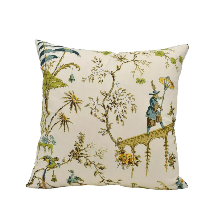 A decorative throw pillow with a floral and bird motif, featuring a person holding an umbrella and a bird in flight.
