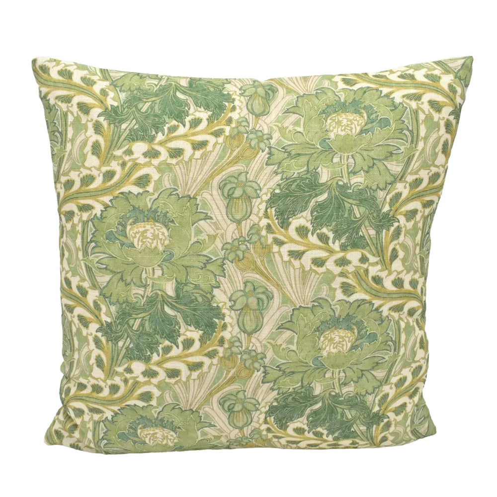 A decorative throw pillow with a repeating pattern of green and white flowers and leaves.